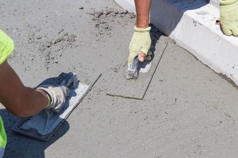 concrete-repair-contractors GVG Concrete crew hand-troweling and edging a fresh concrete slab
