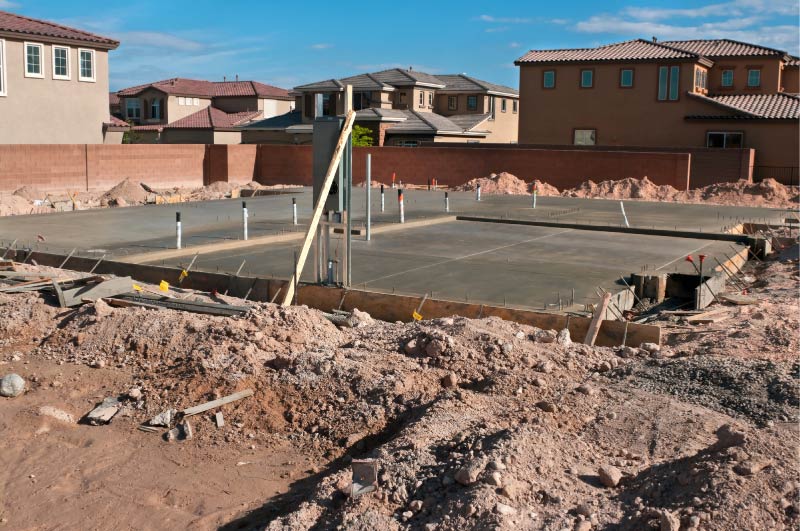 Poured concrete foundation with rebar for new residential construction in Tulare County